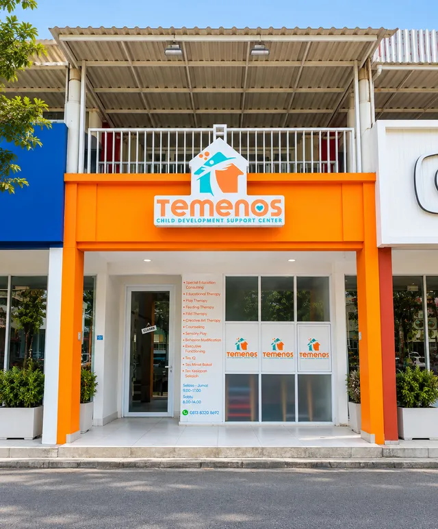 Orange Temenos storefront with a sign above glass entrance doors
