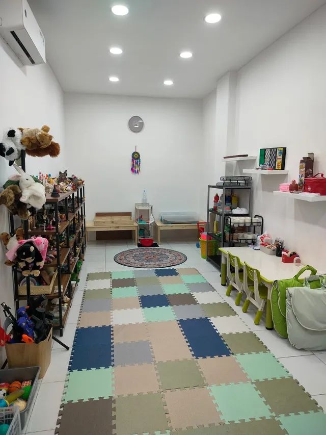 Playroom with toy shelves and colorful floor mats